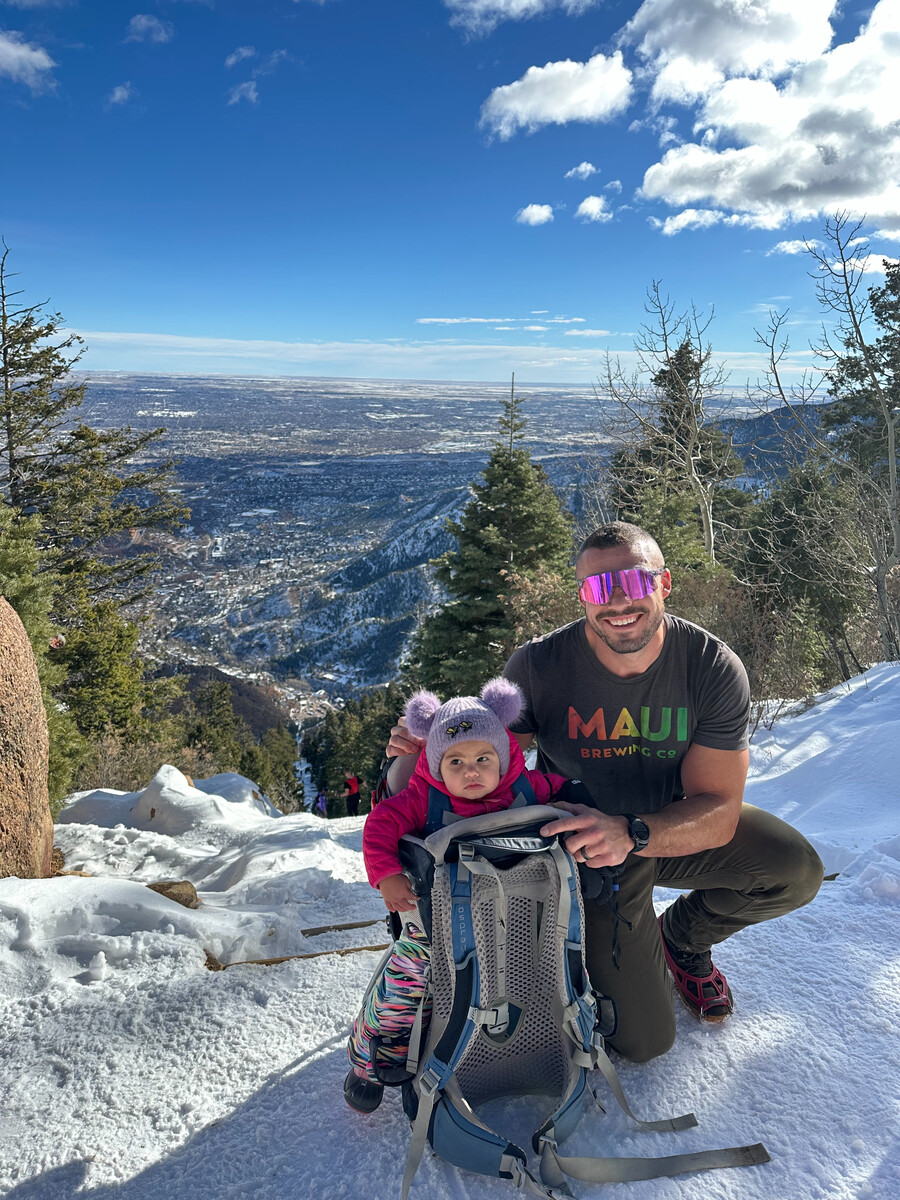 Logan hiking in winter with daughter in carrier